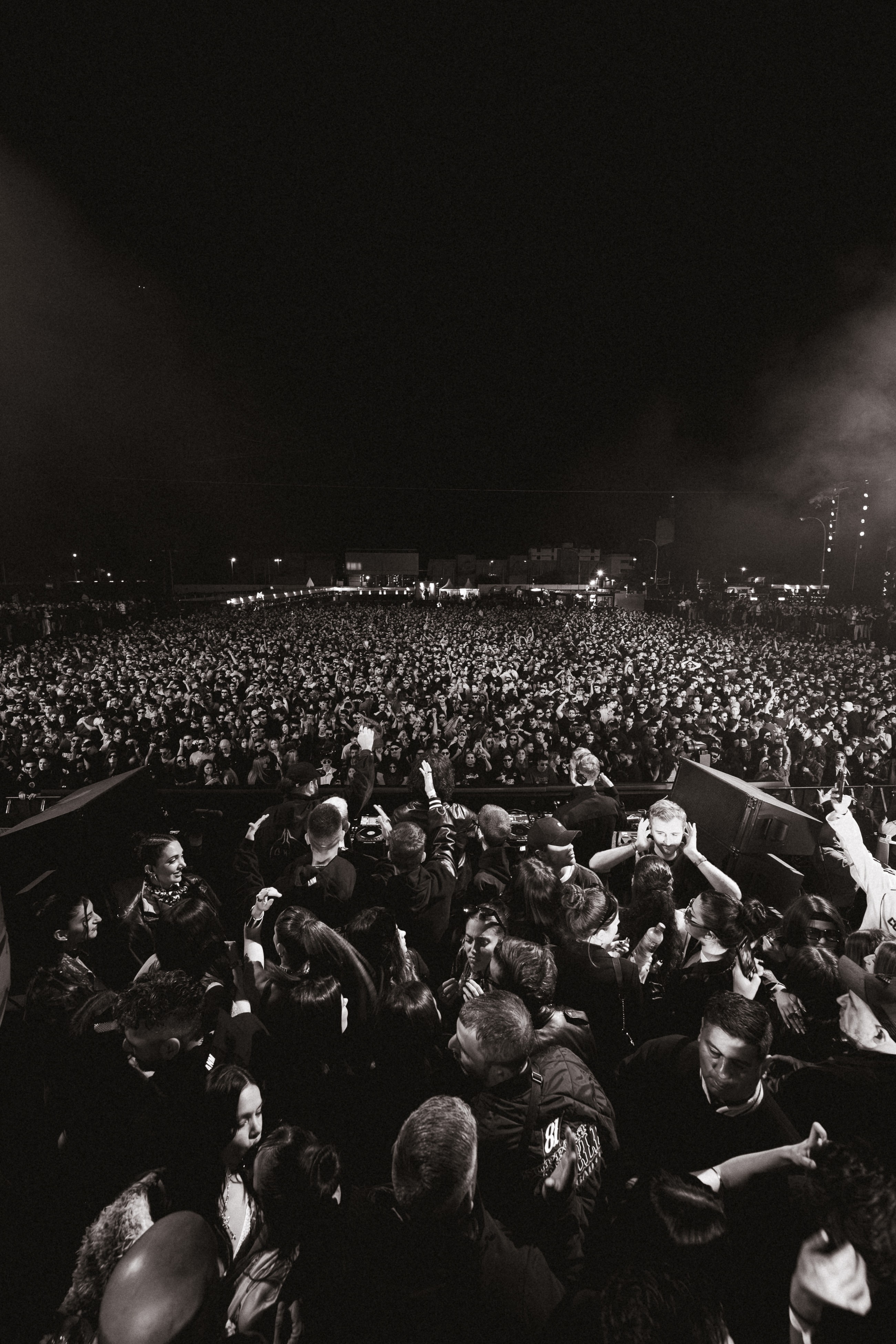 Black and white photo of a women performing modern dance on a dark background.
