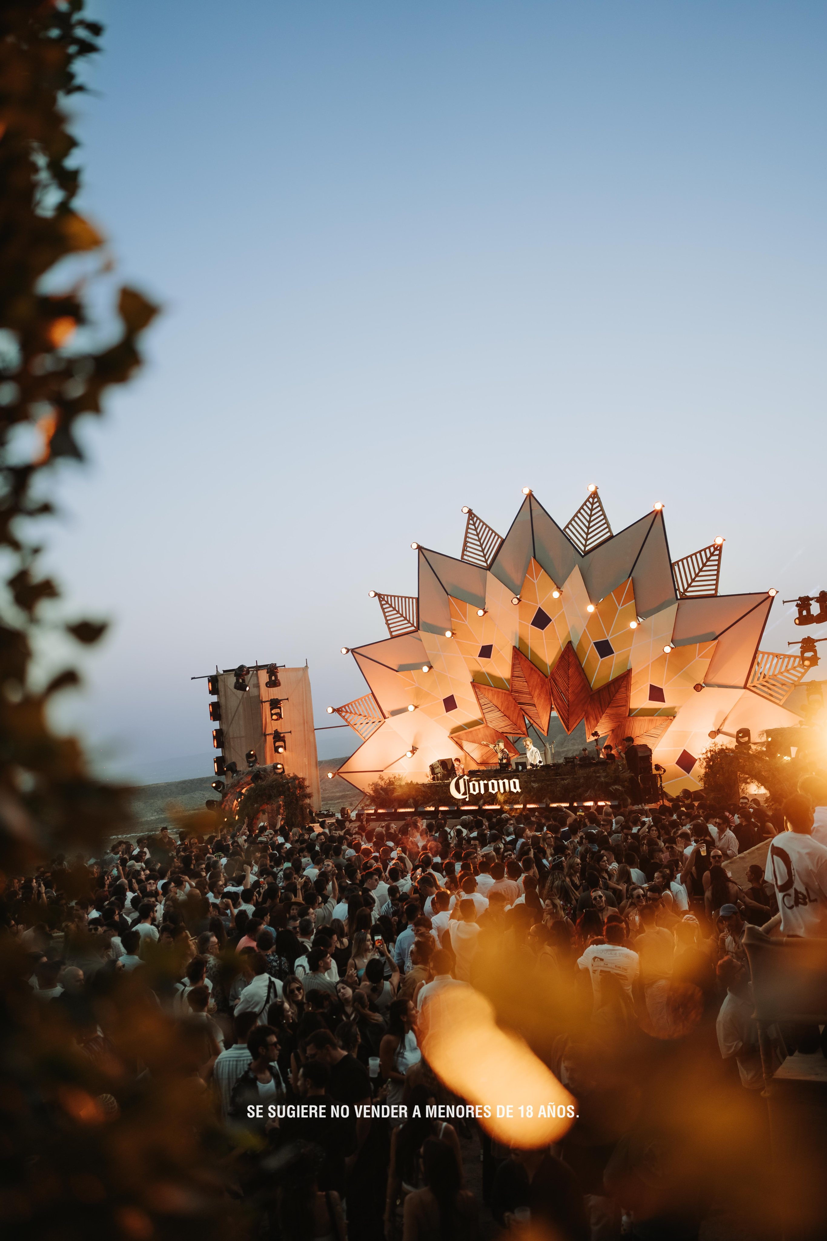 Black and white portrait of a dance instructor posing in front of a dark background.